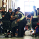 Anita Cameron is hoisted out of her scooter by Capitol police during the McConnell “die-in.”
